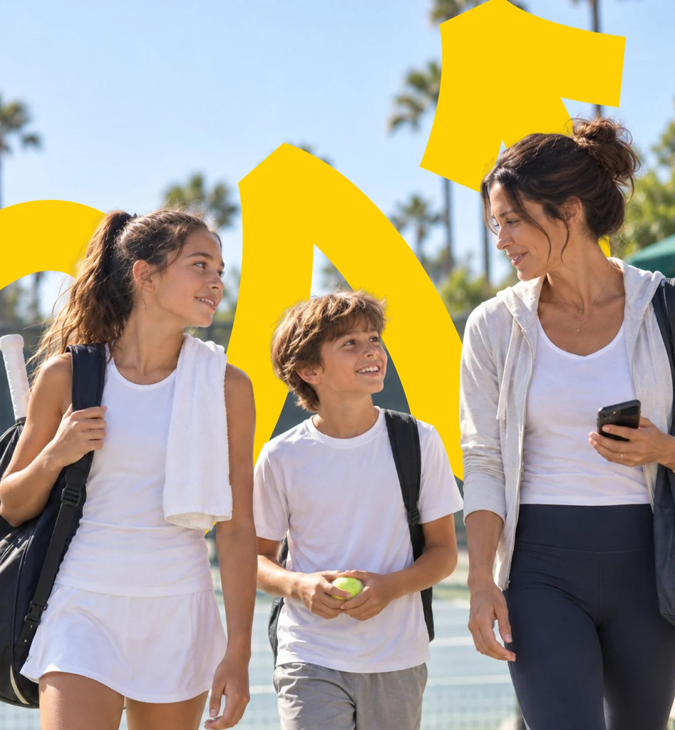 A mother and two kids walking off a sunny tennis court