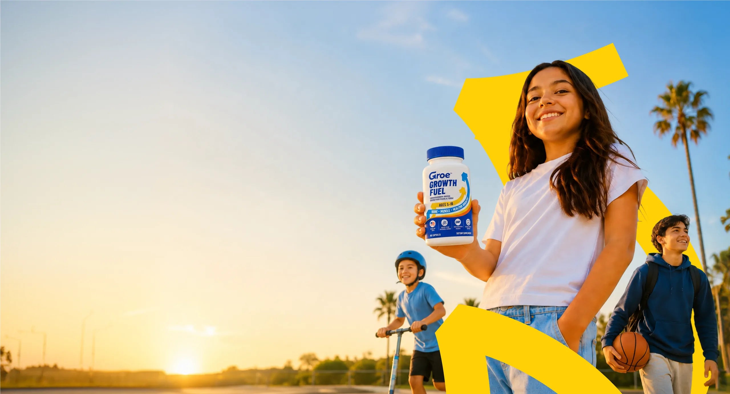 Three kids outdoors at sunset — one holding a bottle of Groe Growth Fuel, one on a scooter, one with a basketball.