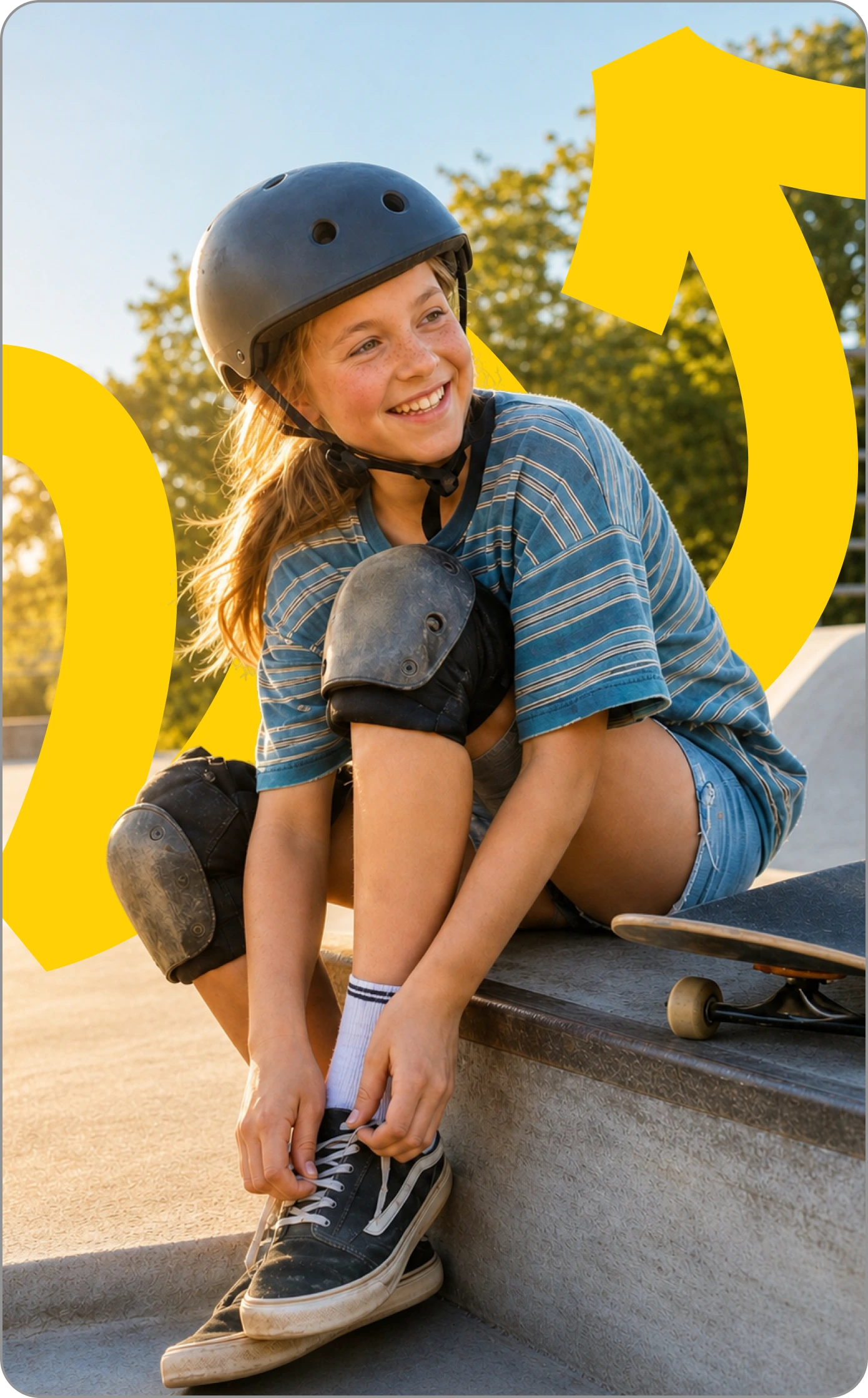 Girl in a helmet lacing her shoe beside a skateboard.