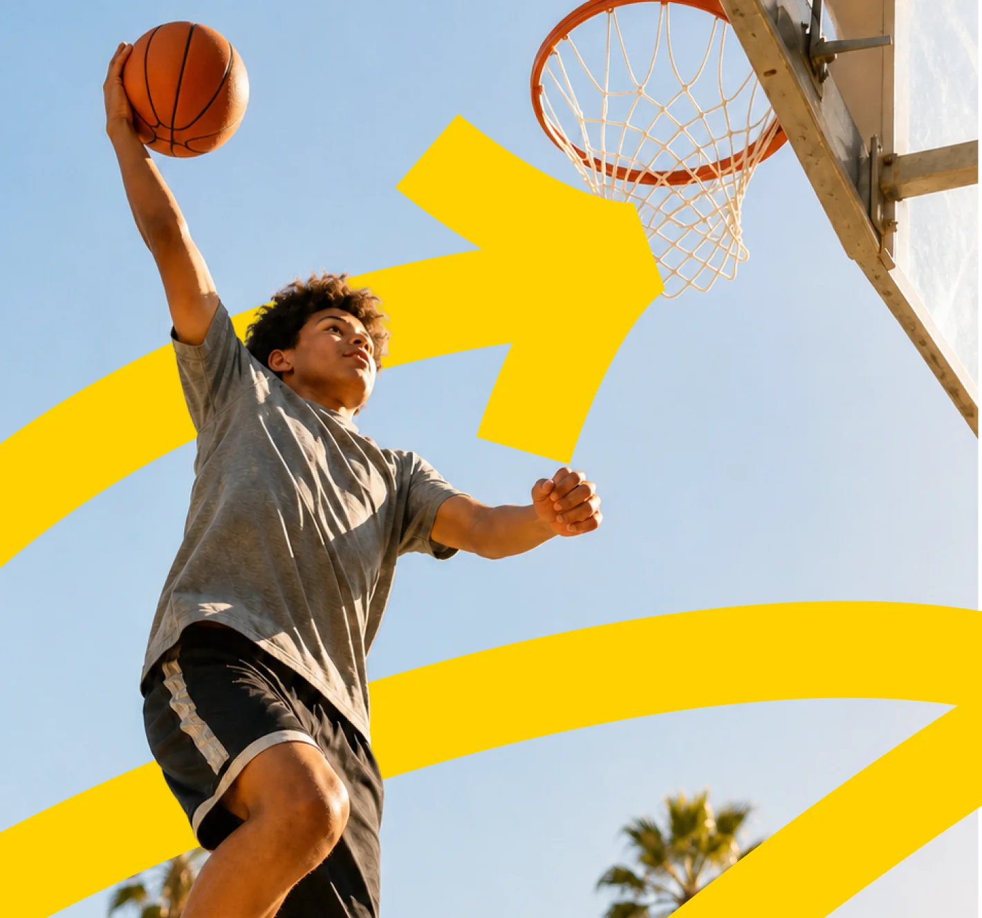 A teen athlete going up for a dunk